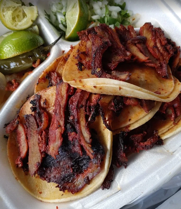 Close-up of tacos with grilled meat, cilantro and lime